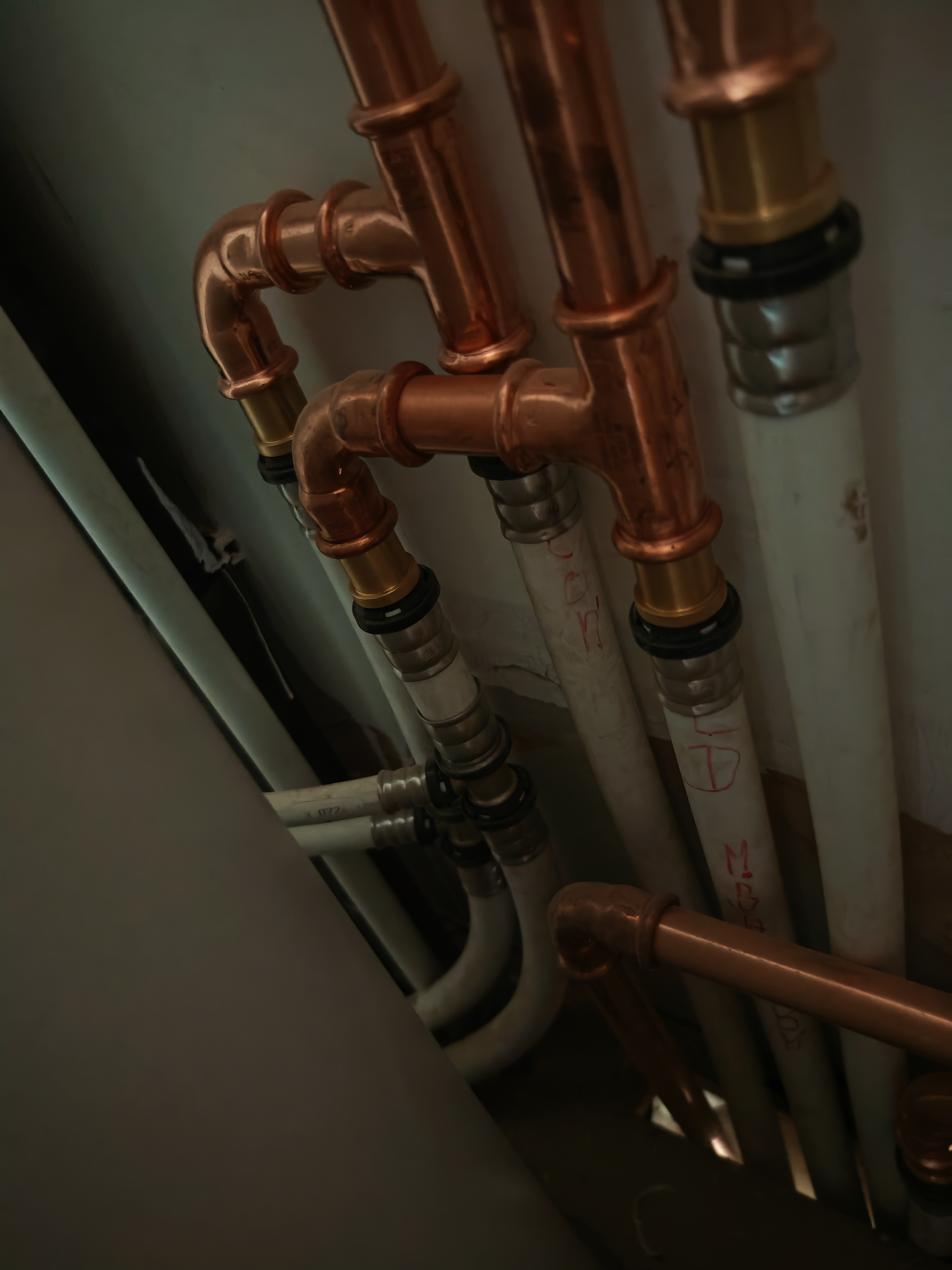 Copper heating pipework installation in service cupboard