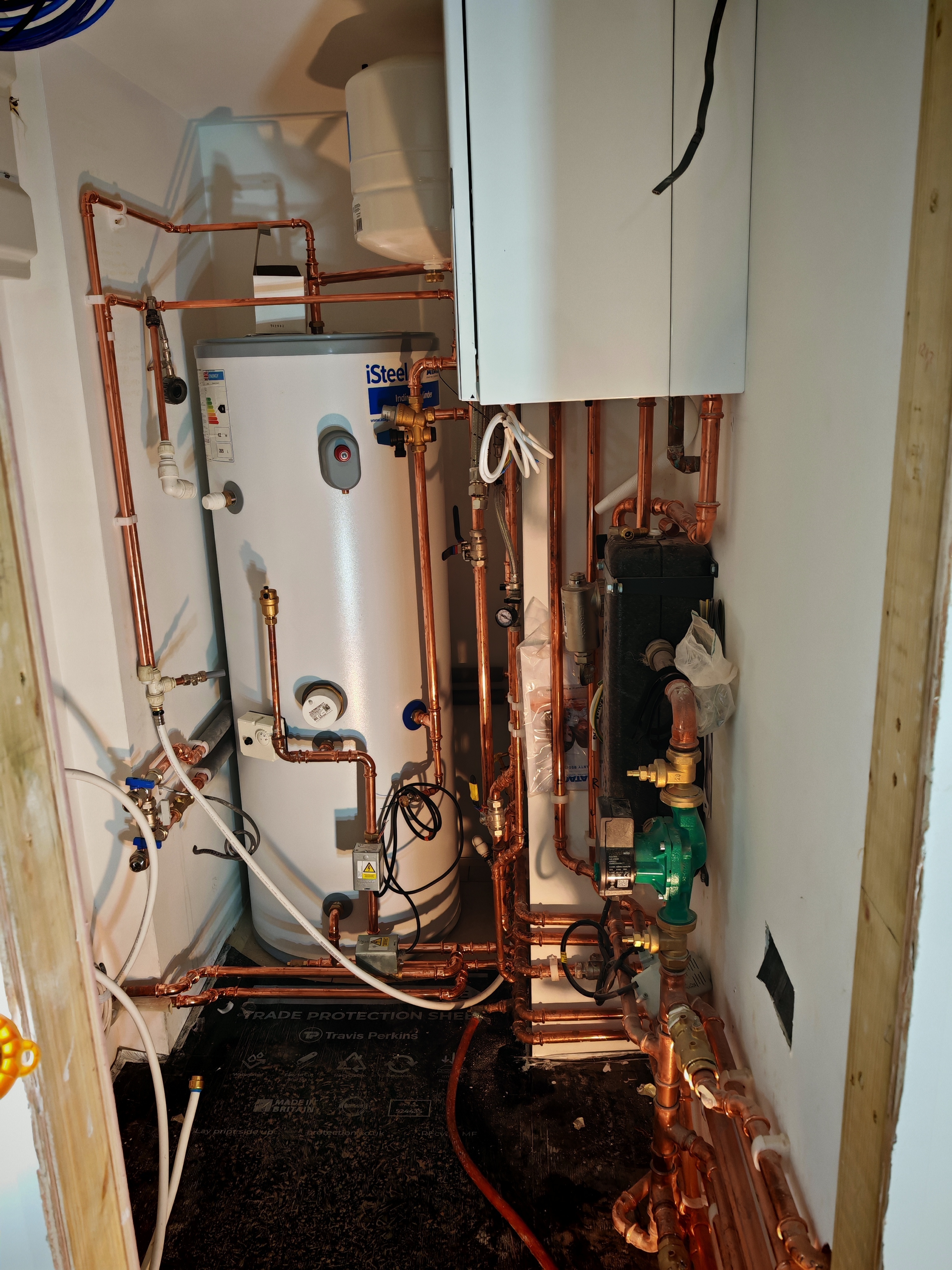 Boiler and pipework installed in cupboard