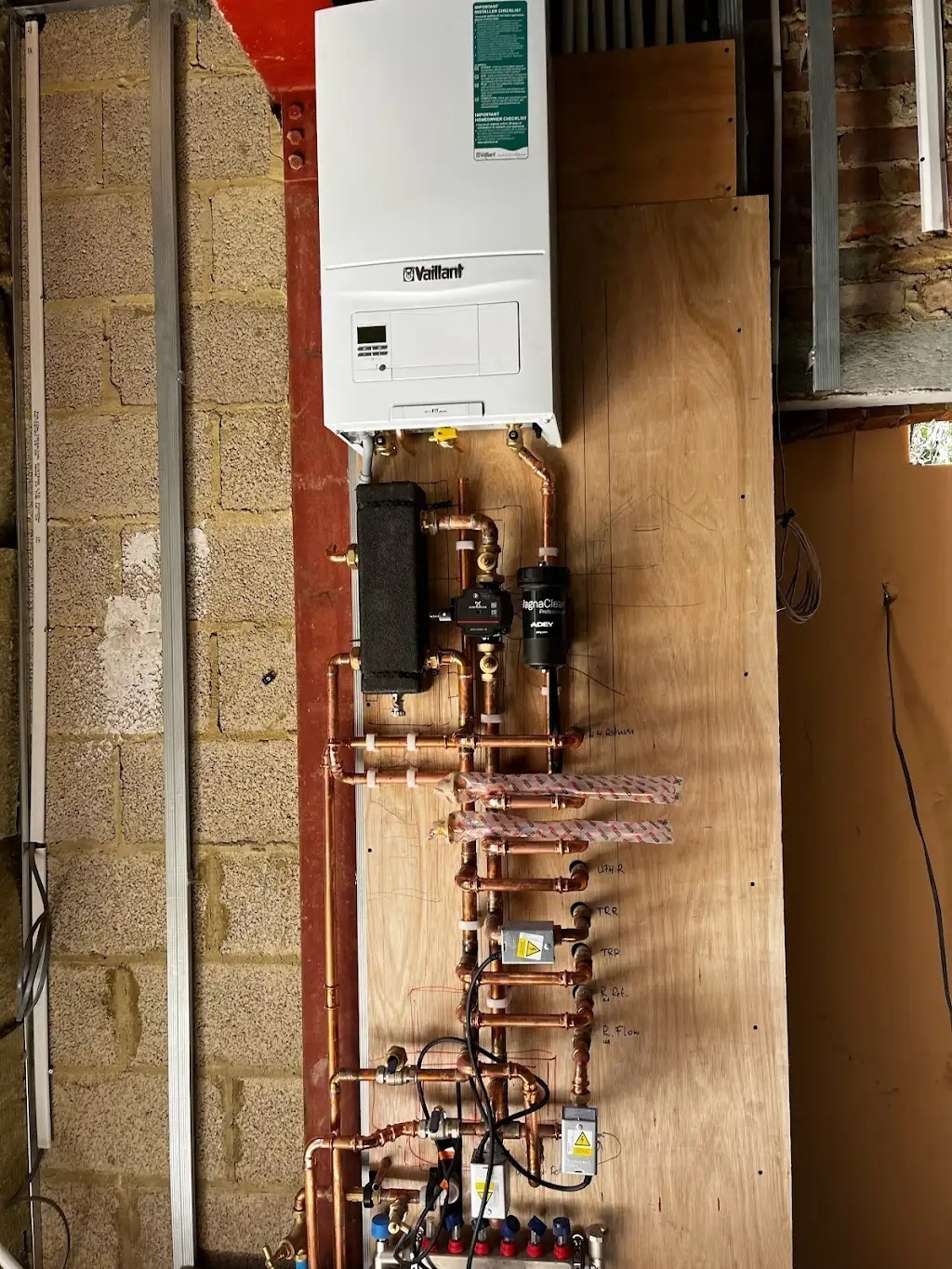 Boiler installation with visible copper pipework